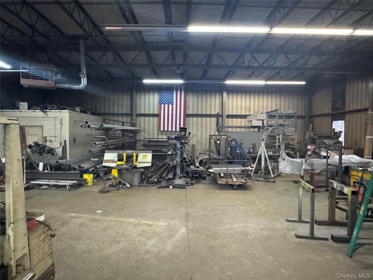 Garage featuring metal wall and a workshop area