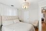 Bedroom featuring a chandelier, wood finished floors, and ornamental molding