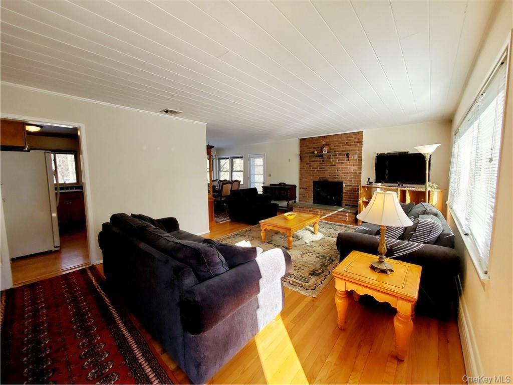 Living room featuring a fireplace, wood finished floors, and visible vents