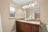 The Primary EN SUITE BATH features dual sinks and a large tiled walk-in shower.
