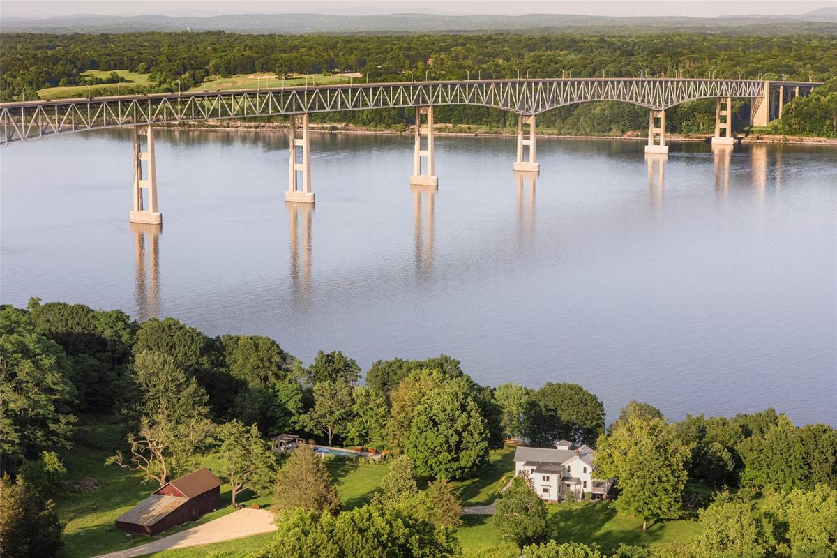 Aerial view of a notable bridge and a heavily wooded area