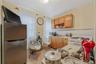 Kitchen featuring appliances with stainless steel finishes, light countertops, light tile patterned floors, open shelves, and decorative backsplash