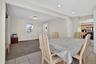 Dining space featuring light colored carpet, a baseboard heating unit, light tile patterned floors, and recessed lighting