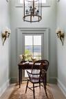 Dining space with a chandelier, an office area, and a water view