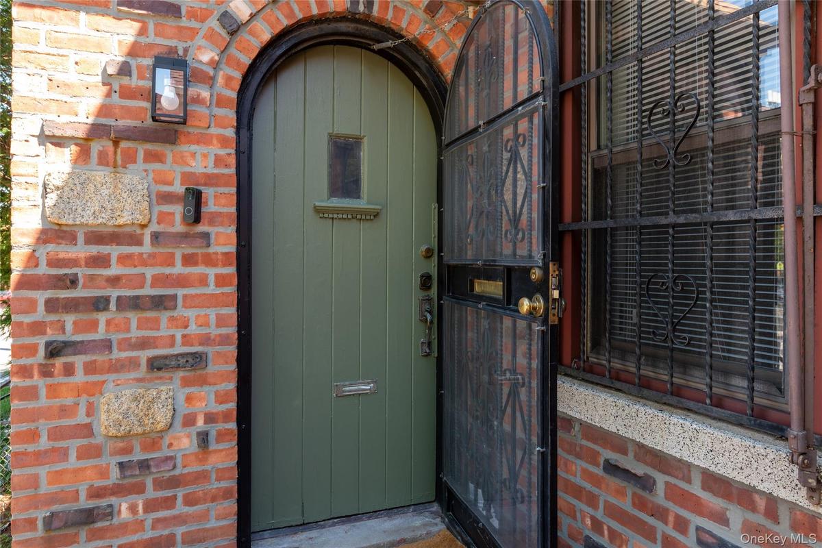 Front door from outside against brick facade