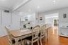 Dining area featuring light wood finished floors, crown molding, and recessed lighting