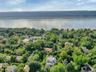 Bird's eye view of a nearby body of water and a heavily wooded area