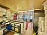 Kitchen featuring refrigerator and white cabinetry