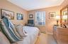 Carpeted bedroom featuring baseboards and a baseboard heating unit