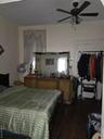 Bedroom featuring dark wood-style flooring and ceiling fan