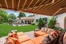 Ground floor brick patio off great room, featuring outdoor lounge area  with awning