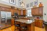 Kitchen featuring a central island with a granite countertop, wood cabinetry, stainless steel appliances