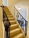 Staircase featuring carpet