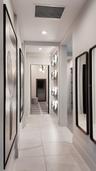 Spacious hallway connecting the primary suite's bedroom, en suite bath and walk-in closet