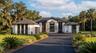 Home is set back in the lot, nestled in 1.5 acres