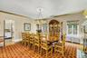 Dining area featuring ornamental molding, radiator, a chandelier, and wood finished floors