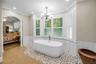Stand-alone-tub, surrounded by bay windows.