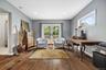 Spacious family room with gleaming hardwood floors, recessed lighting, and French doors providing abundant natural light and easy access to the backya