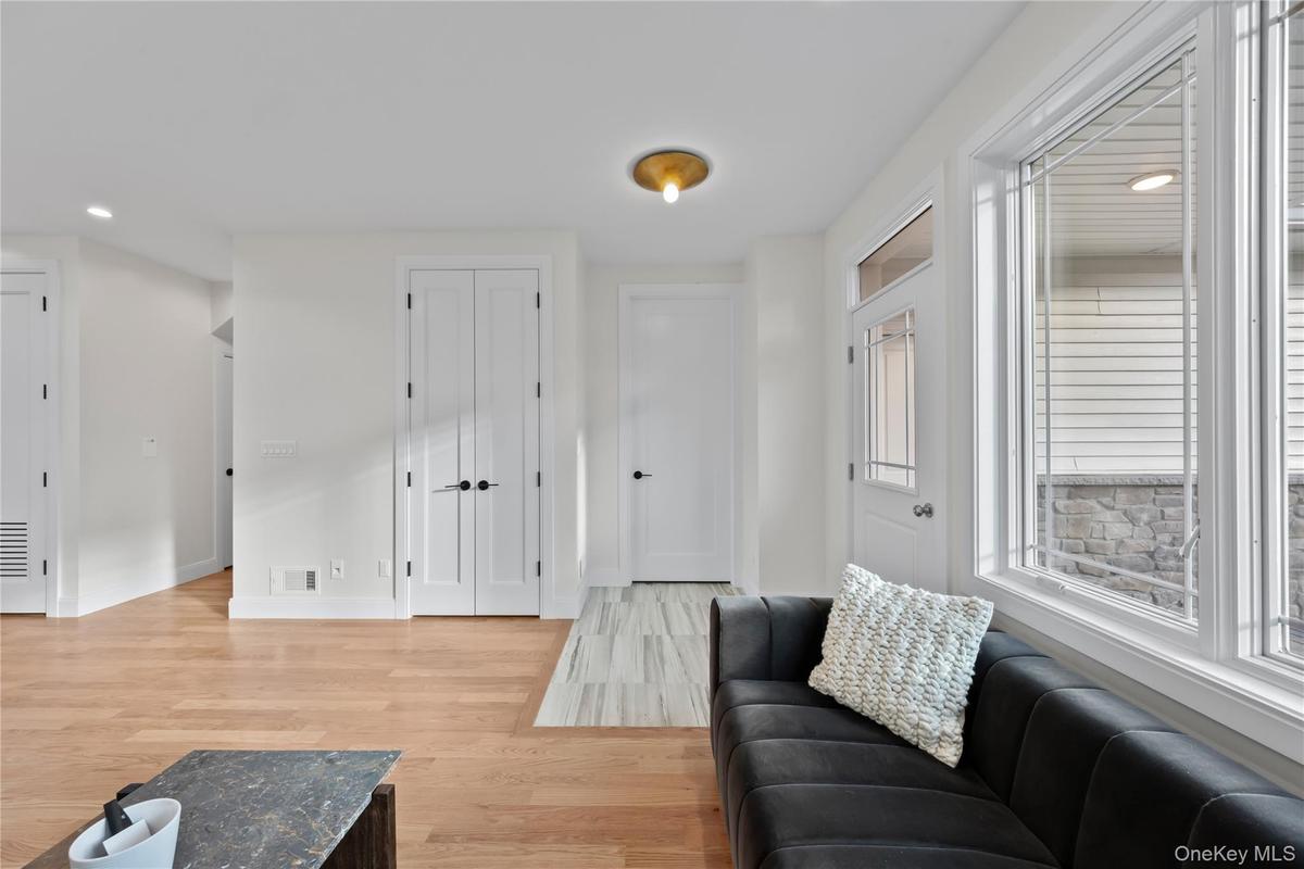 Living room with recessed lighting and light wood-style floors