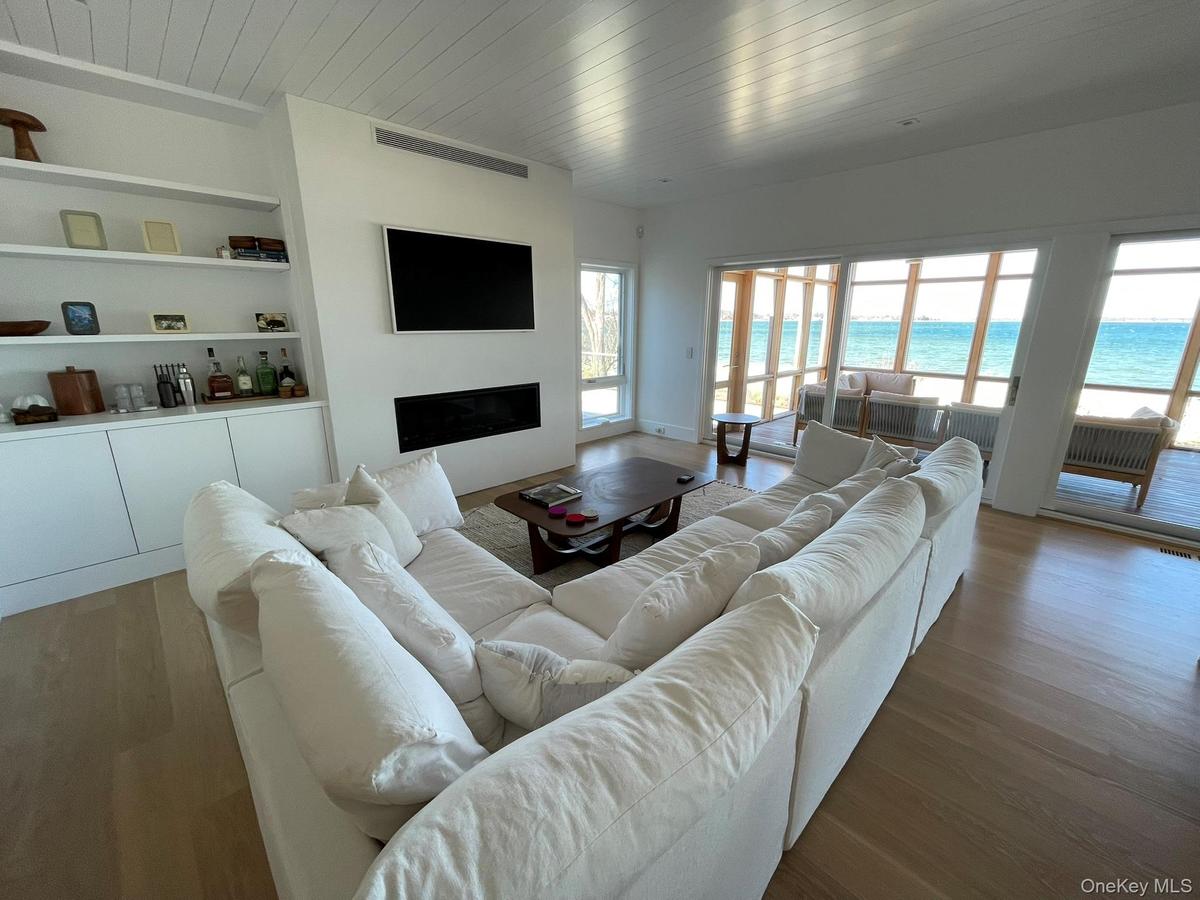 Living room featuring wood ceiling, a fireplace, and plenty of natural light