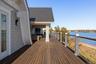Wooden deck featuring a water view and outdoor lounge area
