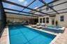 Pool lanai virtually staged with furniture.
