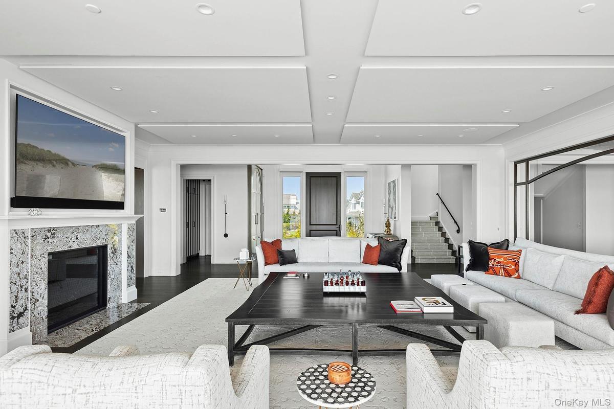 Living area featuring stairway and a fireplace