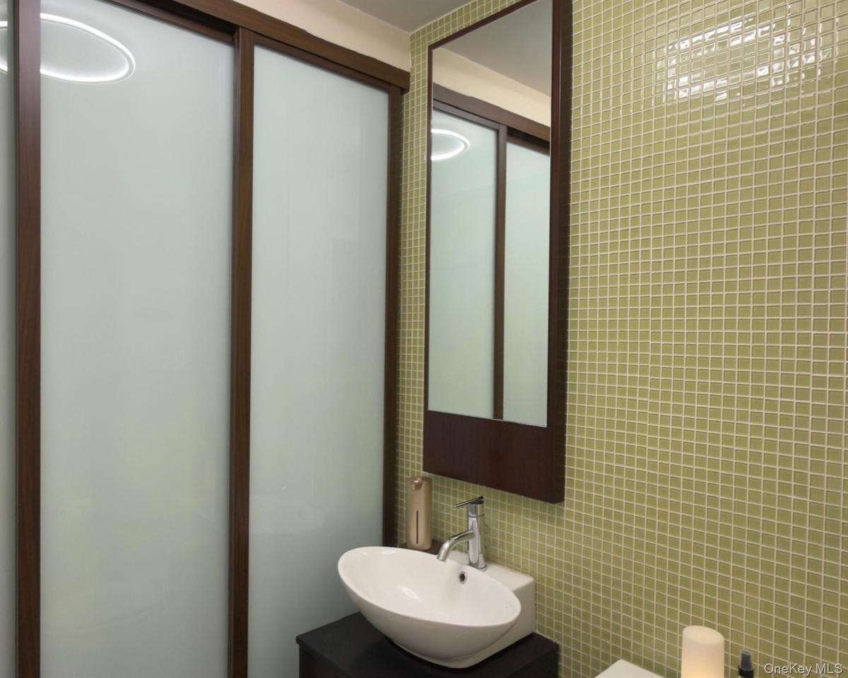 Bathroom with tile walls and vanity
