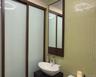 Bathroom with tile walls and vanity