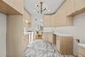 Kitchen featuring light brown cabinetry, modern cabinets, light marble finish flooring, a chandelier, and recessed lighting