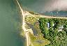 Aerial view of property and surrounding area featuring a nearby body of water