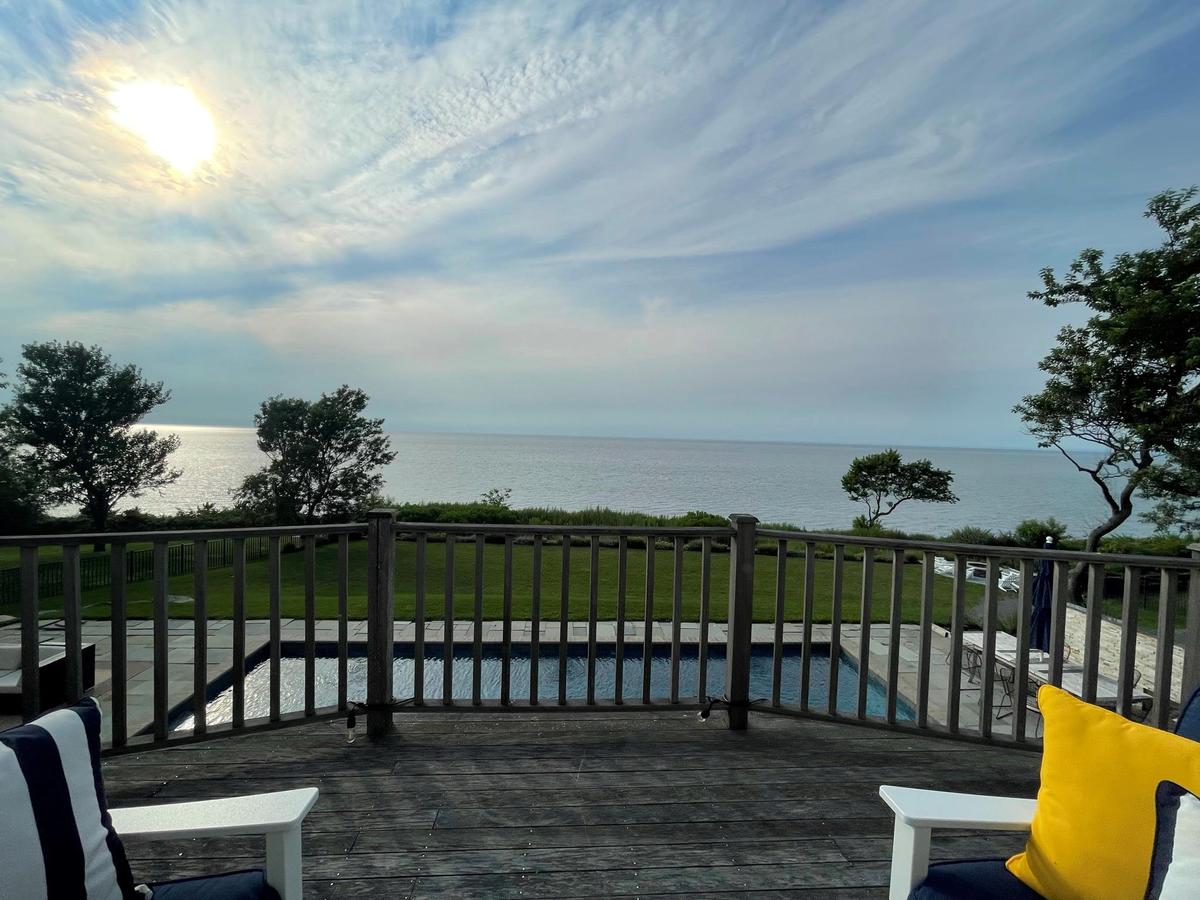 Deck featuring a water view and a lawn