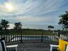 Deck featuring a water view and a lawn