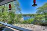Covered upper back porch with dining table overlooking Great Pond