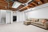 Finished basement featuring washing machine and dryer and stairway