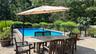View of pool with outdoor dining space, fence, a fenced in pool, and a patio