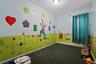 Room featuring carpet flooring, painted walls with a mural, and a window with curtains