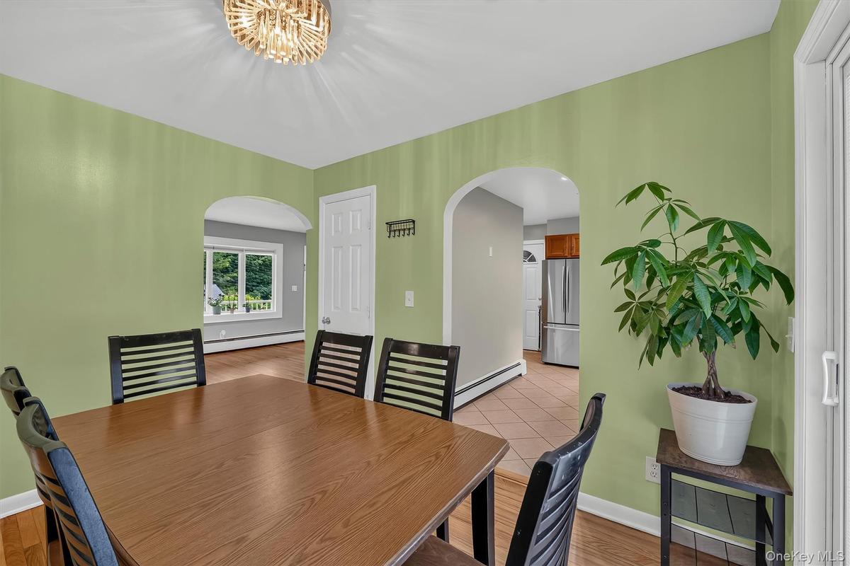 Bright dining room offers a comfortable setting for meals with an open view into the kitchen.