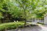 View of grassy yard featuring a porch
