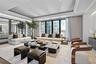 Living room with recessed lighting, a raised ceiling, and floor to ceiling windows