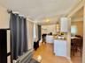 4 - Kitchen with white cabinets, light wood-style flooring, light countertops, a sink, and gas range
