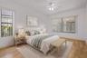 The spacious primary bedroom provides a peaceful retreat en suite bathroom. - virtually staged