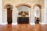 stone wall divides family rm and kitchen