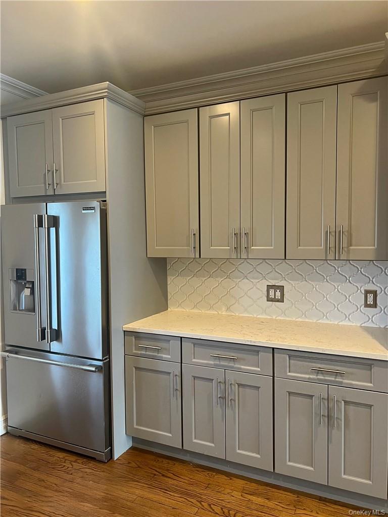 Lots of gorgeous gray cabinets that go up to the ceiling!