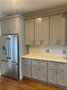 Lots of gorgeous gray cabinets that go up to the ceiling!