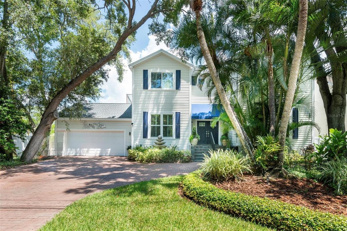 Front of home, mature landscaping, beautiful old world fountain