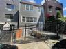 View of front of property with a fenced front yard and a gate
