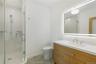 Bathroom featuring a stall shower and vanity