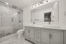 Primary Bath w/Marble tiled walk-in shower, marble tiled flooring and vanity w/ double sinks