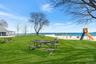View of property's community featuring a yard and a water view